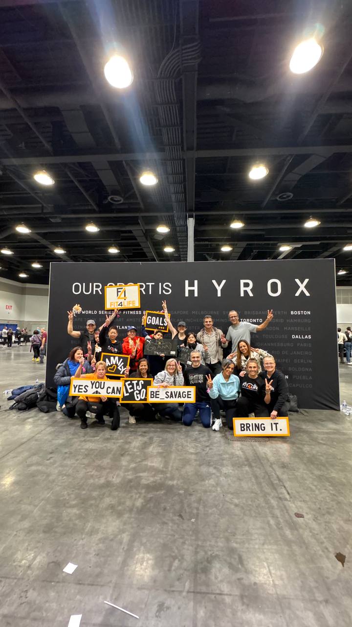 Fit4Life crew in front of the 'Our sport is HYROX' wall