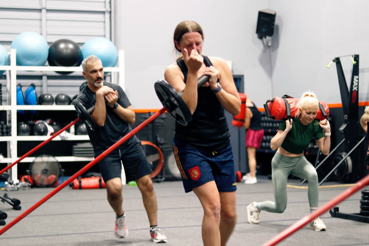 Fit 4 Life athlete grinding through a HYROX sled push